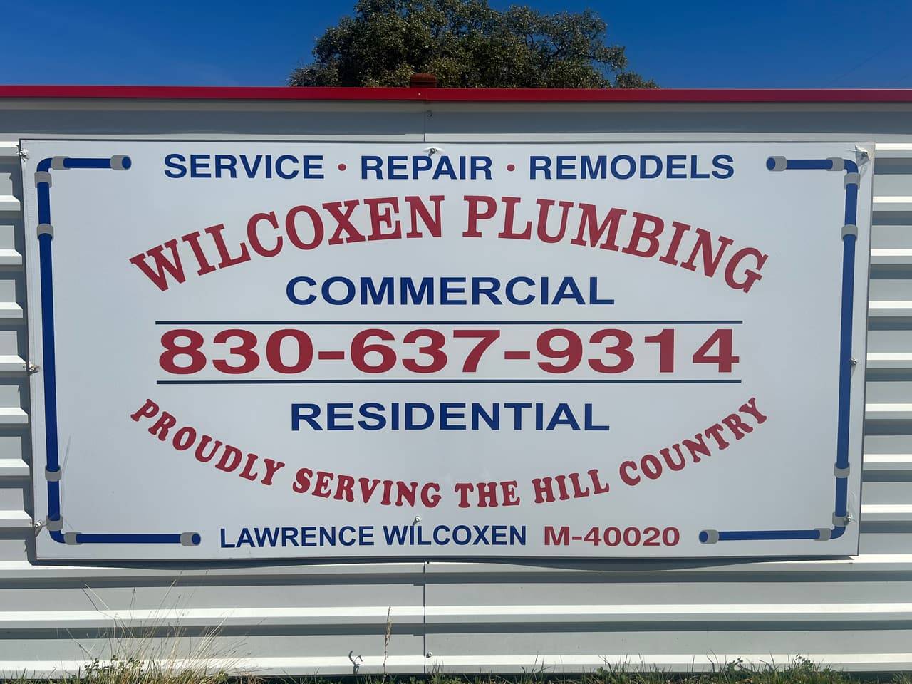 Wilcoxen Plumbing sign reading service, repair, remodels, commercial, residential, 830-637-9314, proudly serving the Hill Country