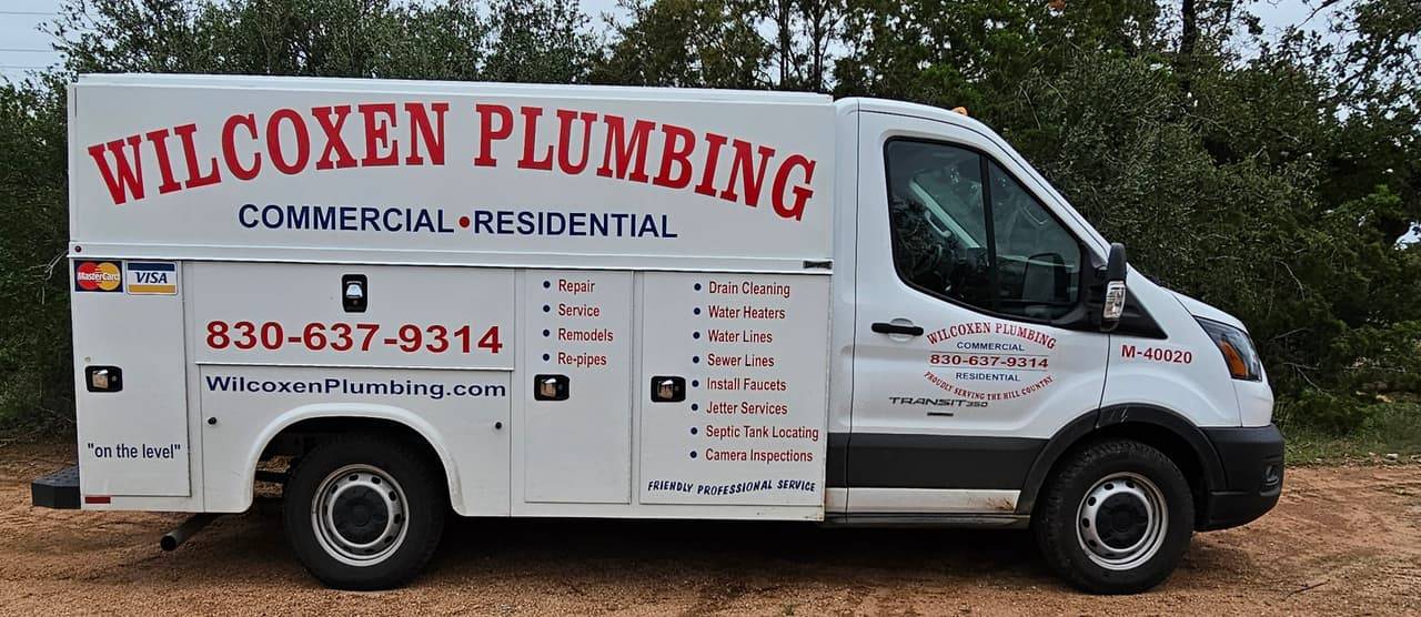Wilcoxen Plumbing truck lettered with drain cleaning, water heaters, water lines, sewer lines, faucets, jetter services, septic tank locating and camera inspections